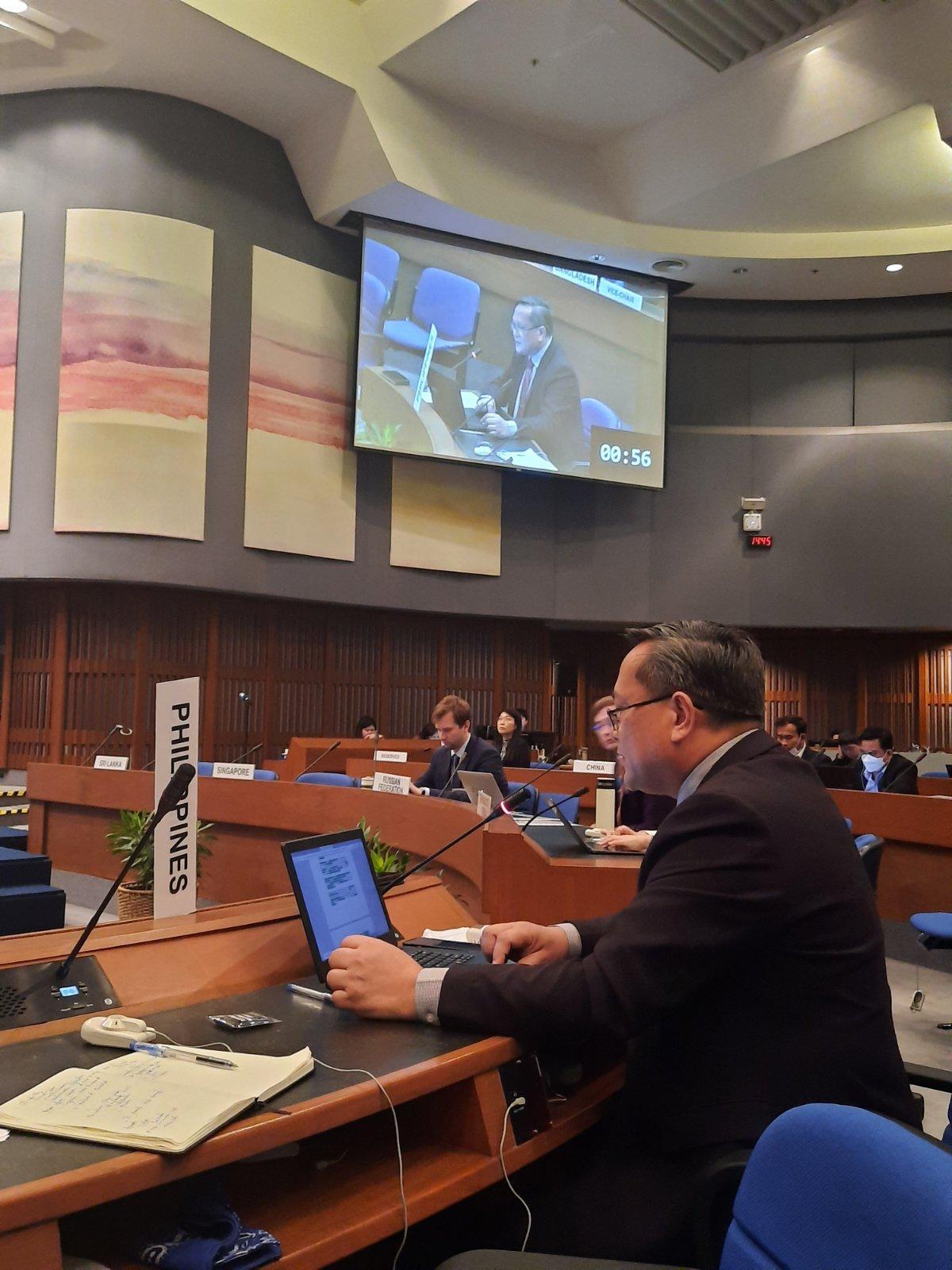 A person sitting at a desk in front of a projector screen

Description automatically generated with medium confidence