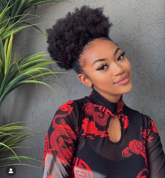 pretty lady rocking single bun with her natural hair
