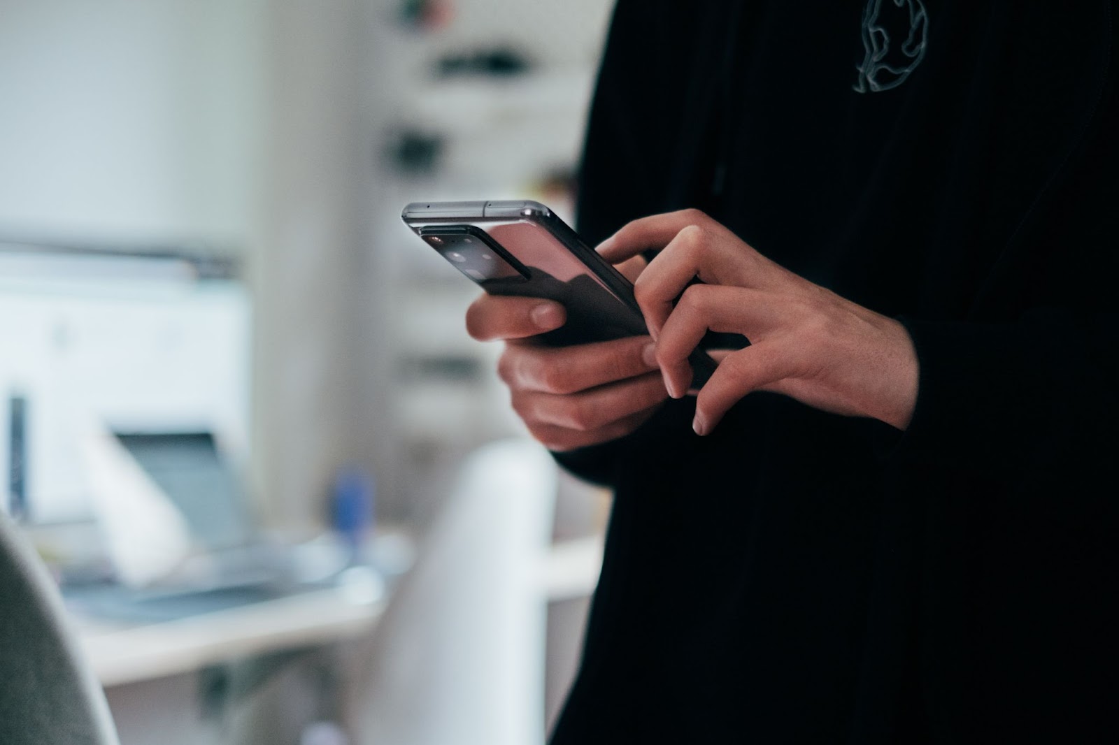 A person holding a black android smartphone