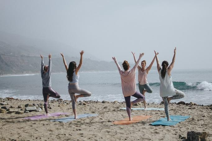 A group of people doing yoga on a beach

Description automatically generated with medium confidence