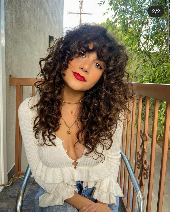pretty lady wearing bang with curls on curly hair