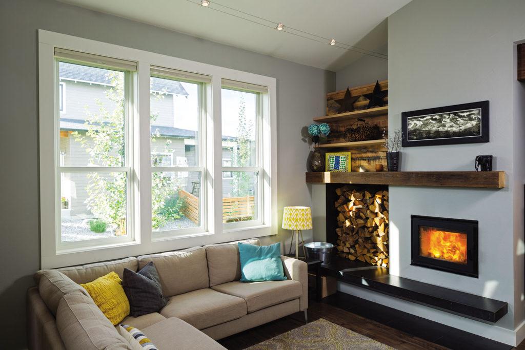 WeServe living room with fireplace and big windows