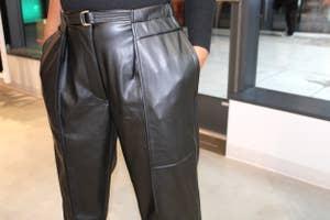 Closeup showing details of black leather pants