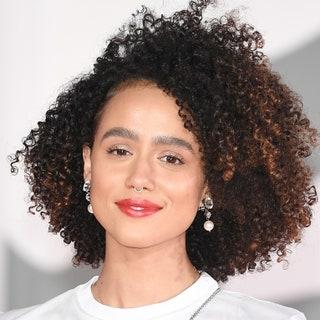 Nathalie Emmanuel on the red carpet with sideparted curly hair