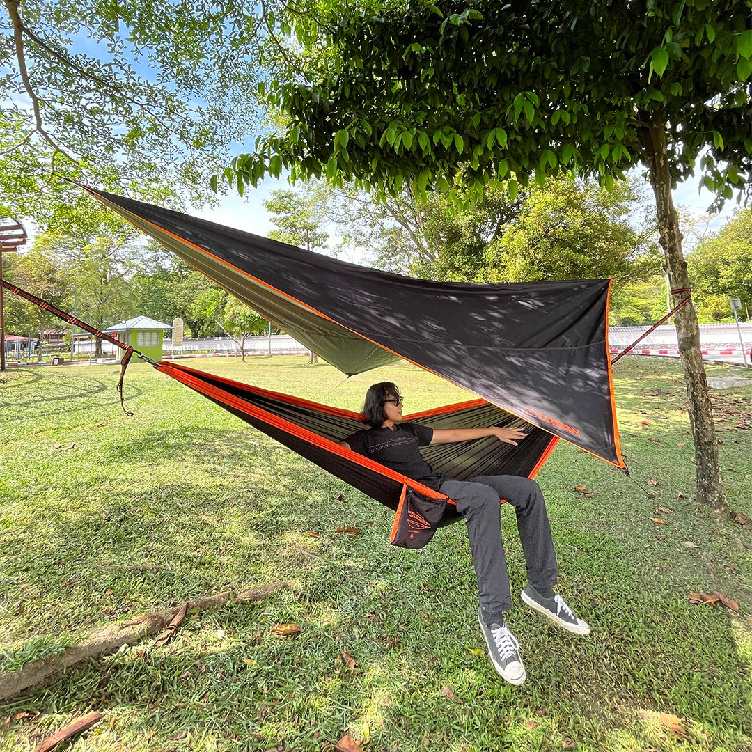 A person sitting in a hammock

Description automatically generated