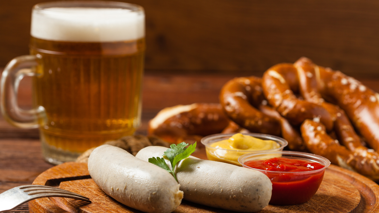 A group of sausages and pretzels on a table

Description automatically generated