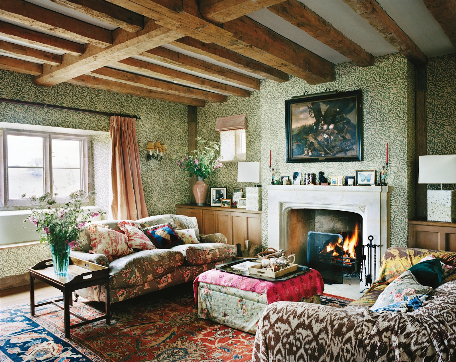 Granny chic design giving a warm living space with colorful wallpaper and furniture