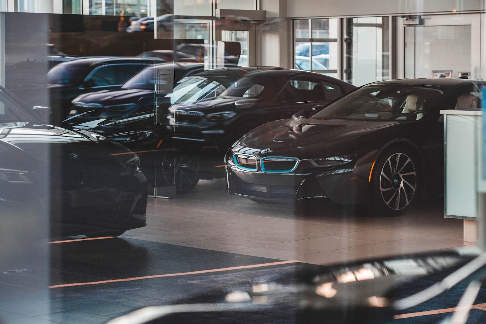BMW sedans inside a dealership.