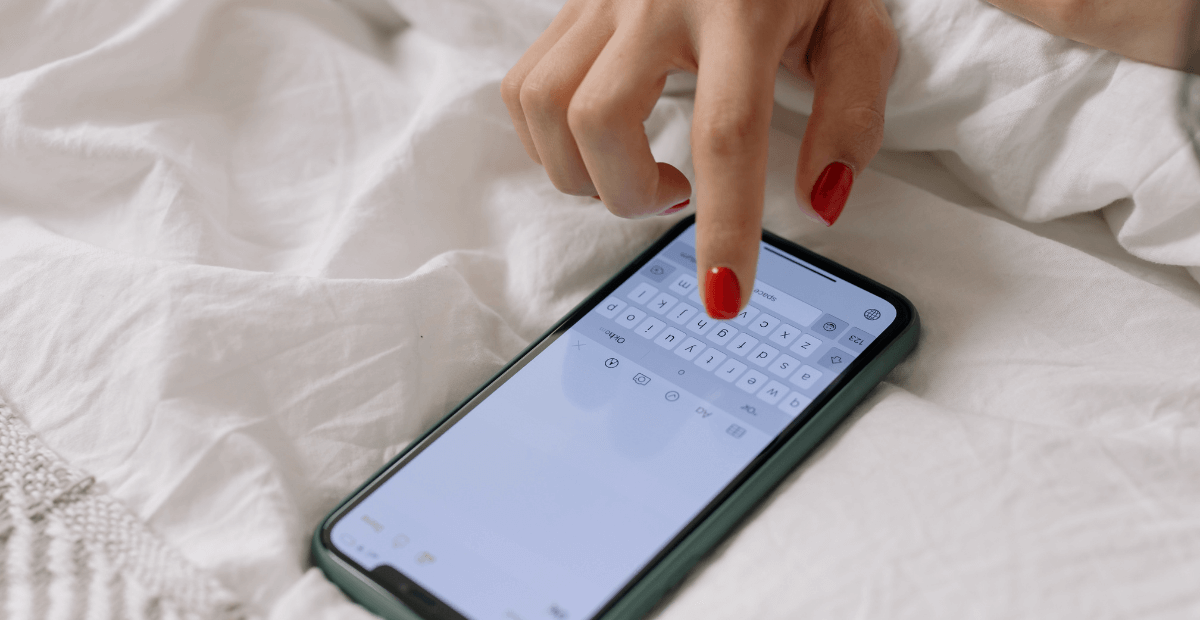 woman typing an SMS on her phone