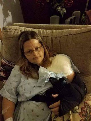 Nurse with injured shoulder resting on couch