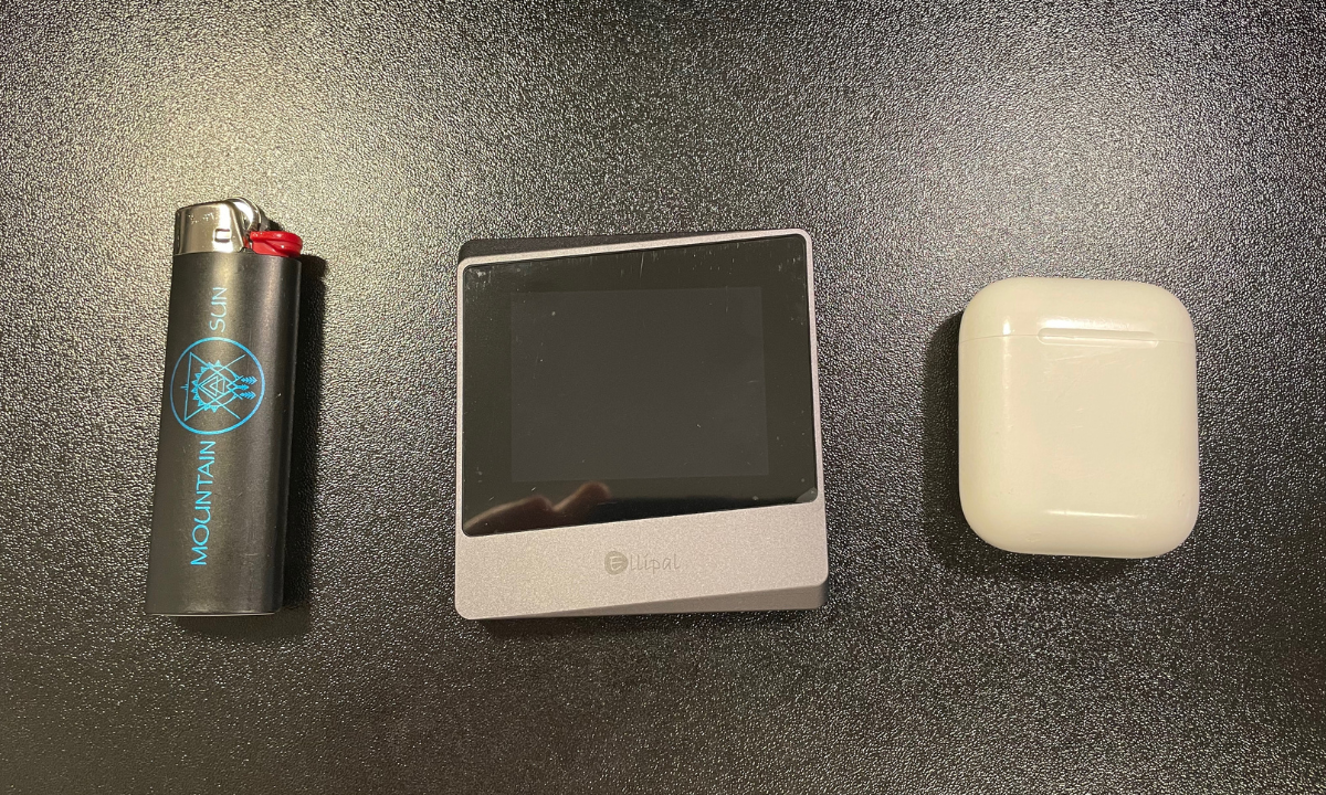 My Ellipal Titan Mini next to a lighter and Airpods for size reference.