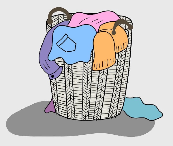 a variety of colored clothes are mixed in a wooden basket that looks dirty