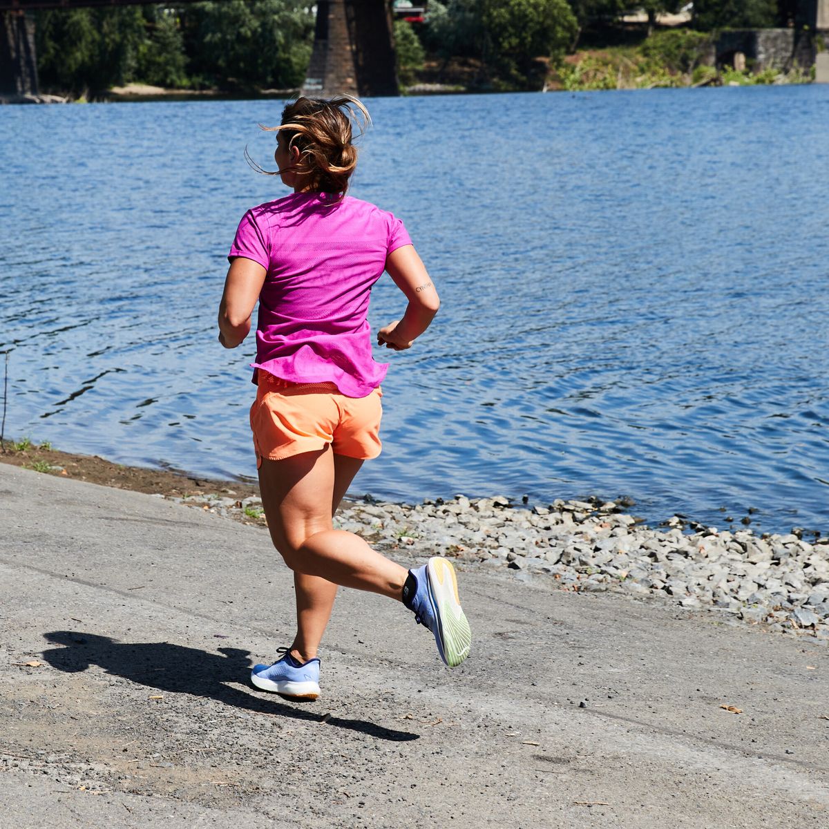 woman running along water