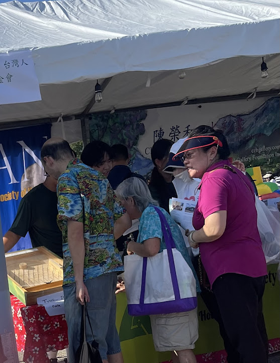 A group of people standing in front of a tent

Description automatically generated