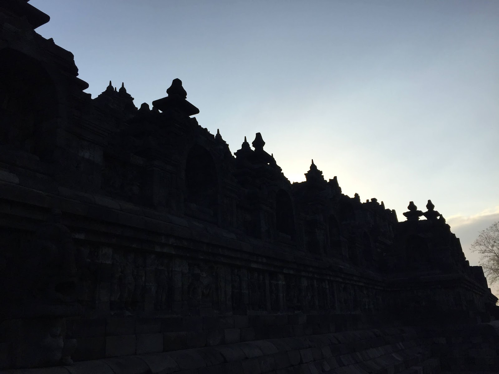 3 days in Yogyakarta, silhouette of Borobudur just after sunrise, side walls of Borobudur, Java, Indonesia