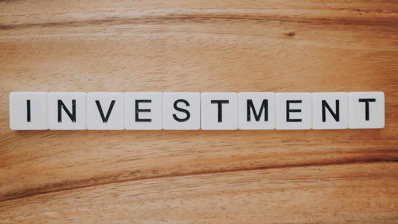 Tiles spelling out investment