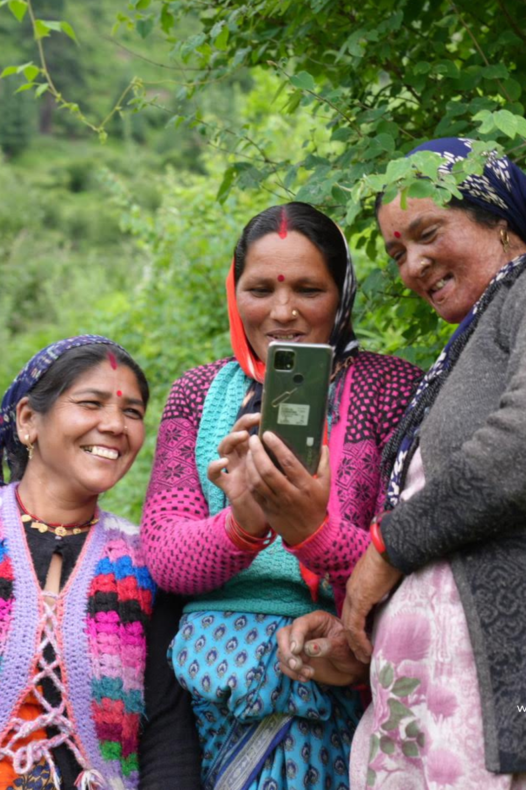 Women learning to use mobile phones to run their business, use UPI payment, and facebook to market their products