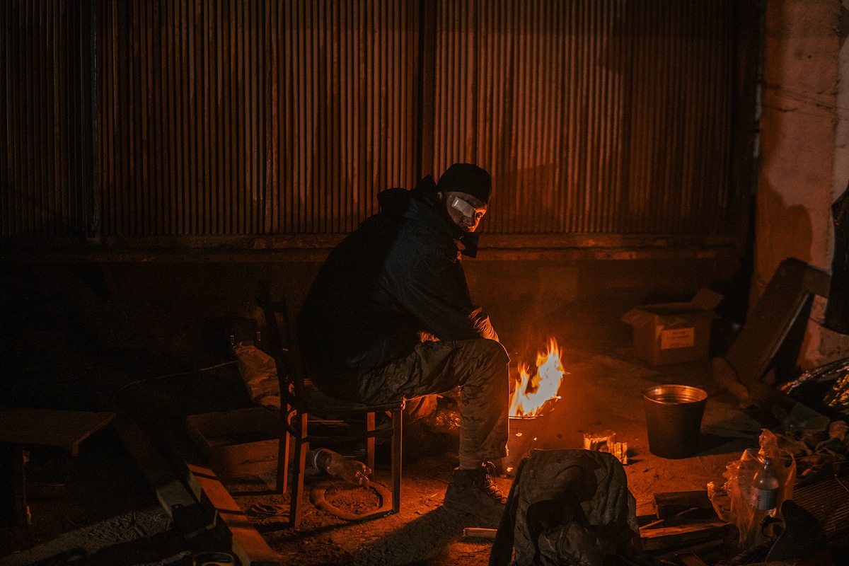 Ukrainian Soldier Warming Himself by a Fire in Mariupol Steel Plant