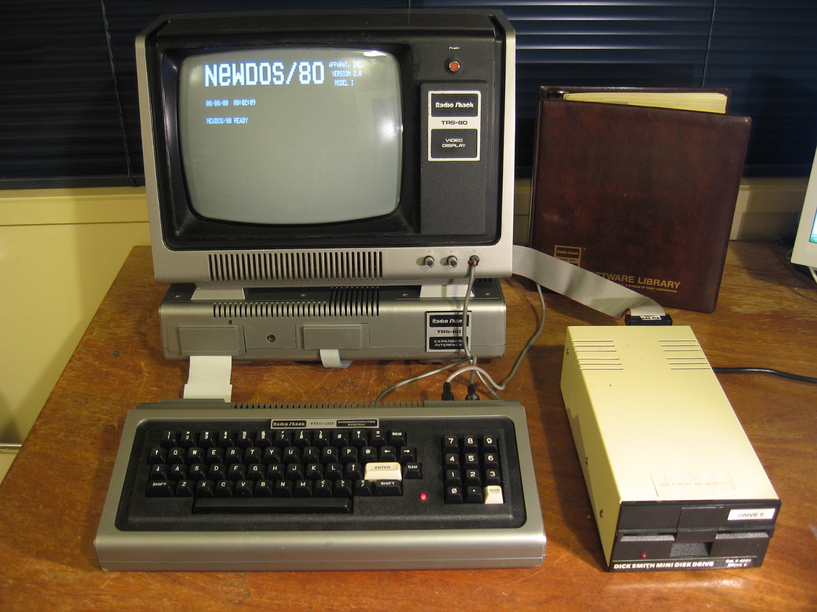 An image on a TRS-80 Model I computer, with several accessories.