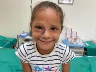 A child with a scar on her face 
Description automatically generated