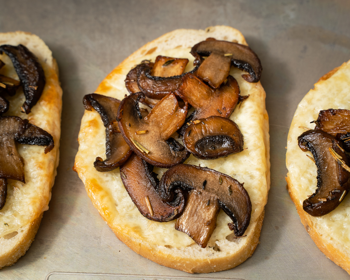 mushroom placed on top of toast with cheese