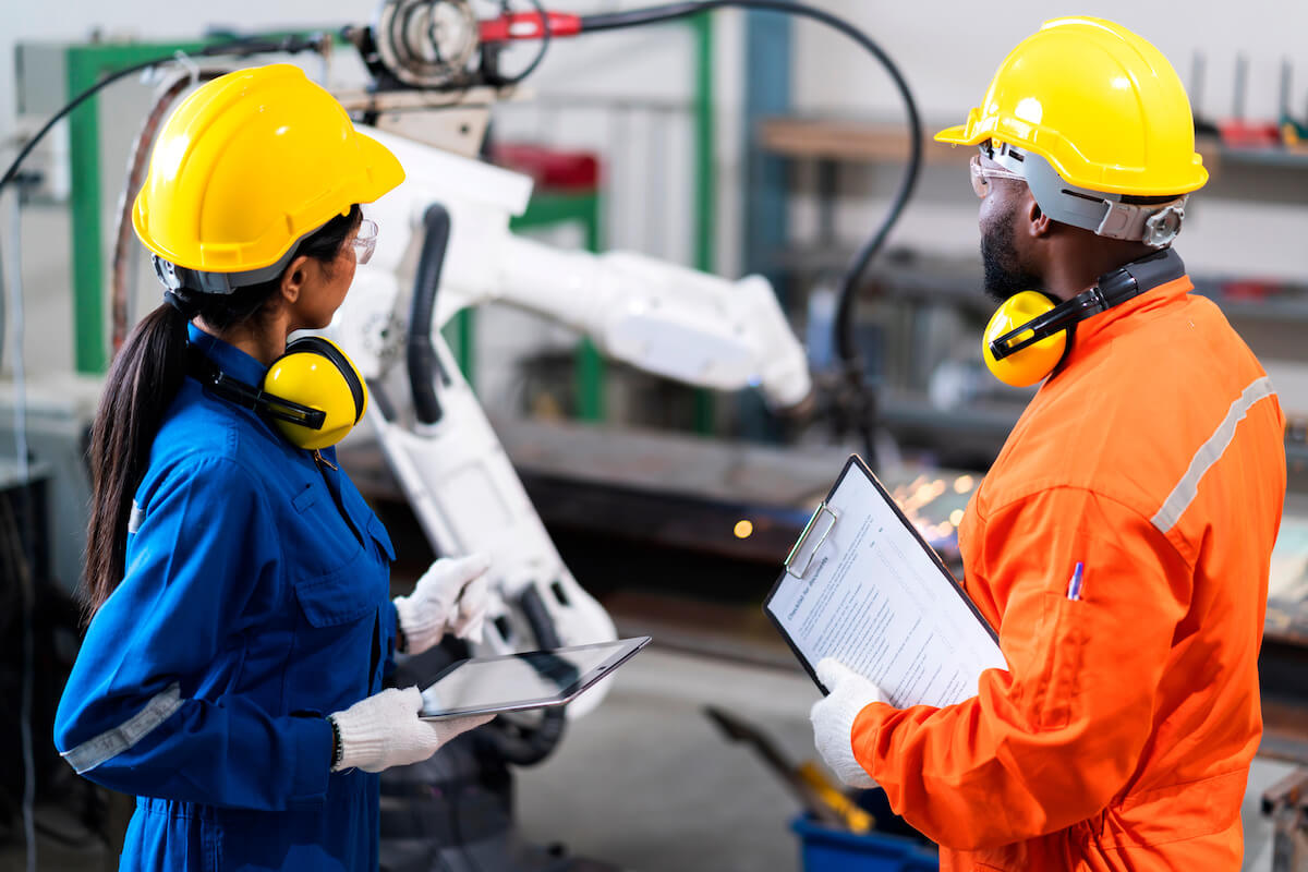 Process safety management: 2 engineers checking a machine