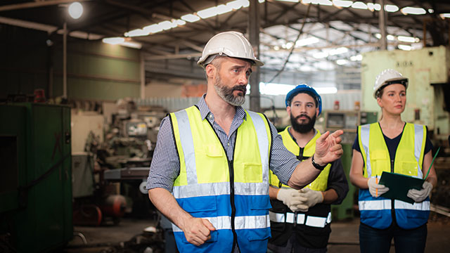 Manager speaking to team of employees