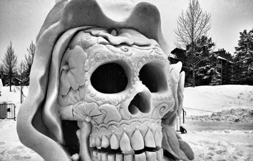 Snow sculpture of ornate skull 