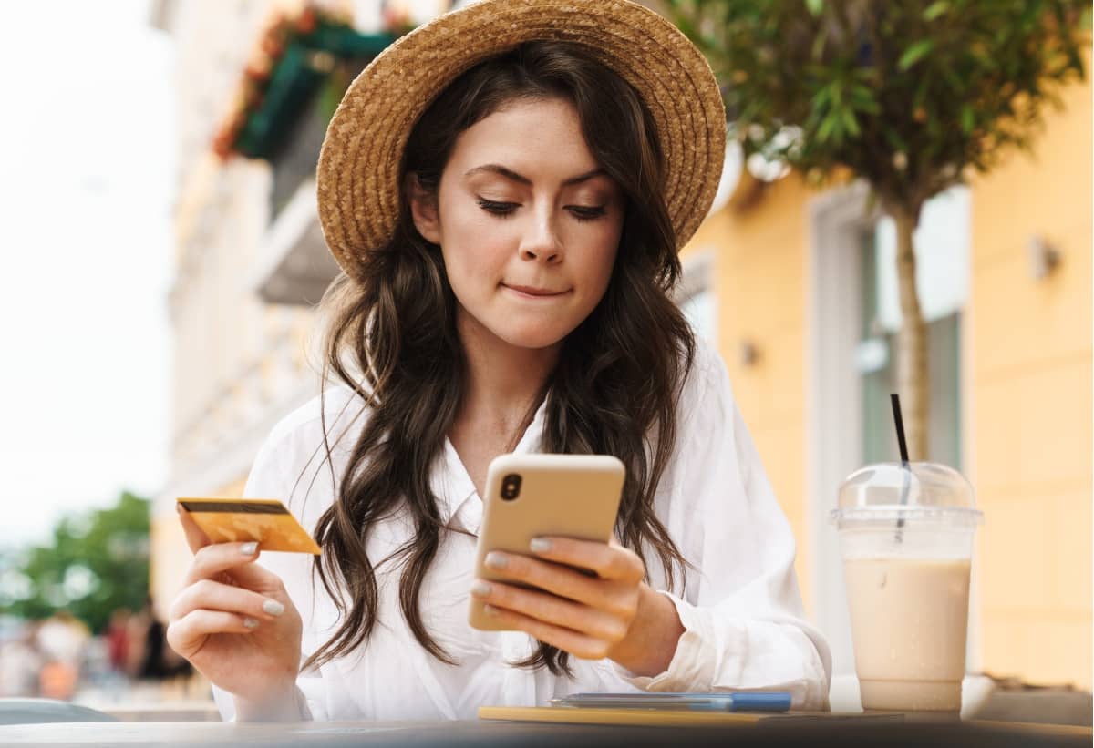 digital marketing strategy - young woman with credit card and mobile phone