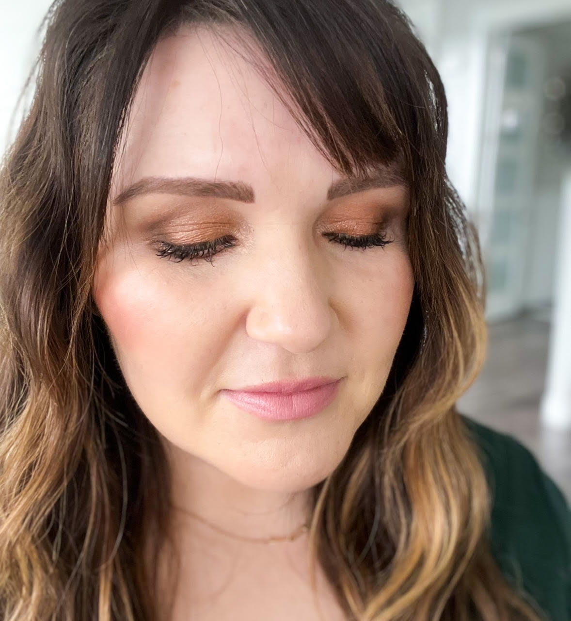 Picture of Kelly Snider with her eyes closed displaying the look she created with the 4 best eyeshadows for beginners 