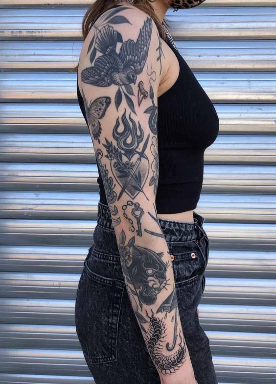 Close up photo of a lady rocking the sleeve  arm tattoo