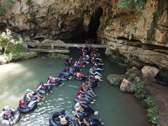 A group of people in a boat on a river

Description automatically generated