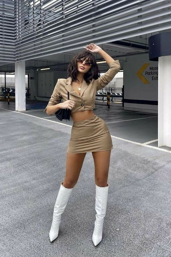 lady wearing brown coordinated set with white knee-high boots