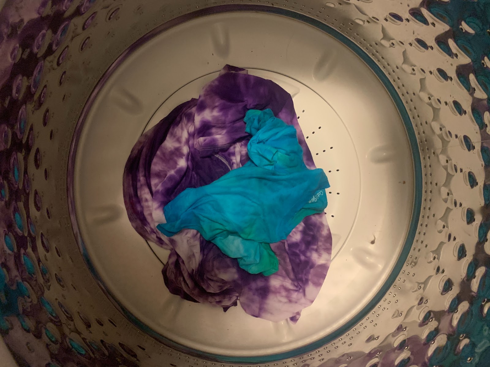 A tie-dyed shirt on its own in the washing machine to prevent it from dying other clothing