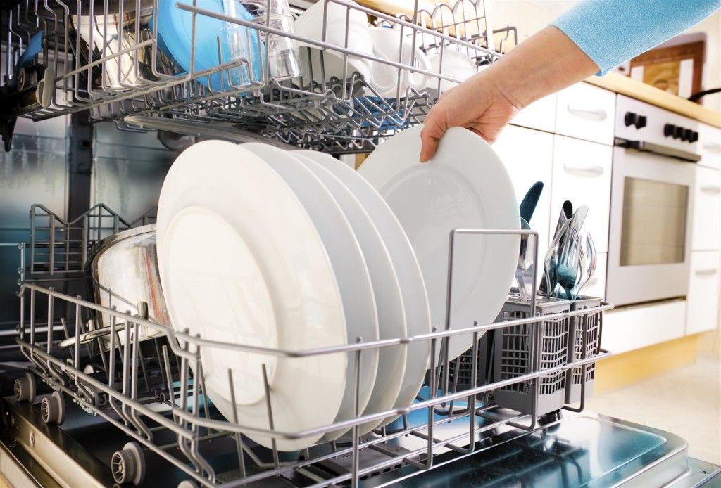 Person Unloading Bad Smelling Dishwasher