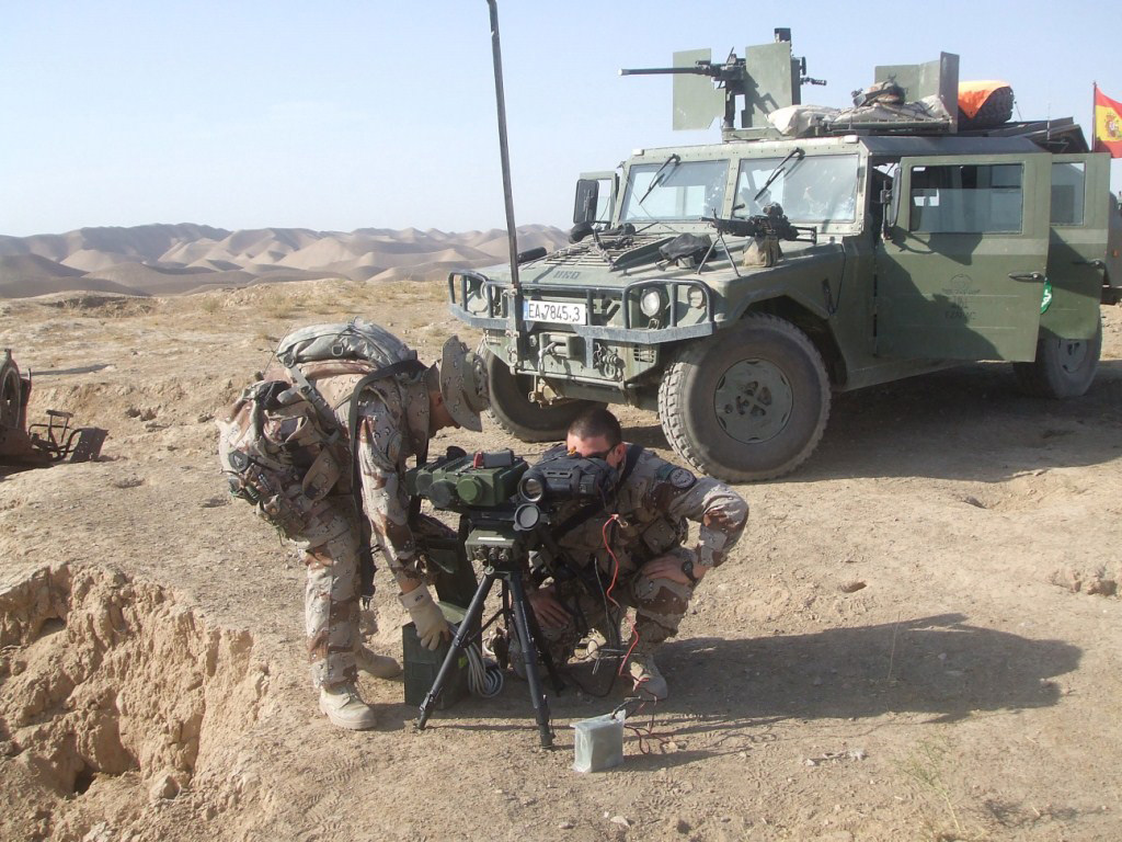 Two soldiers next to a URO VAMTAC deployed in Afghanistan. 