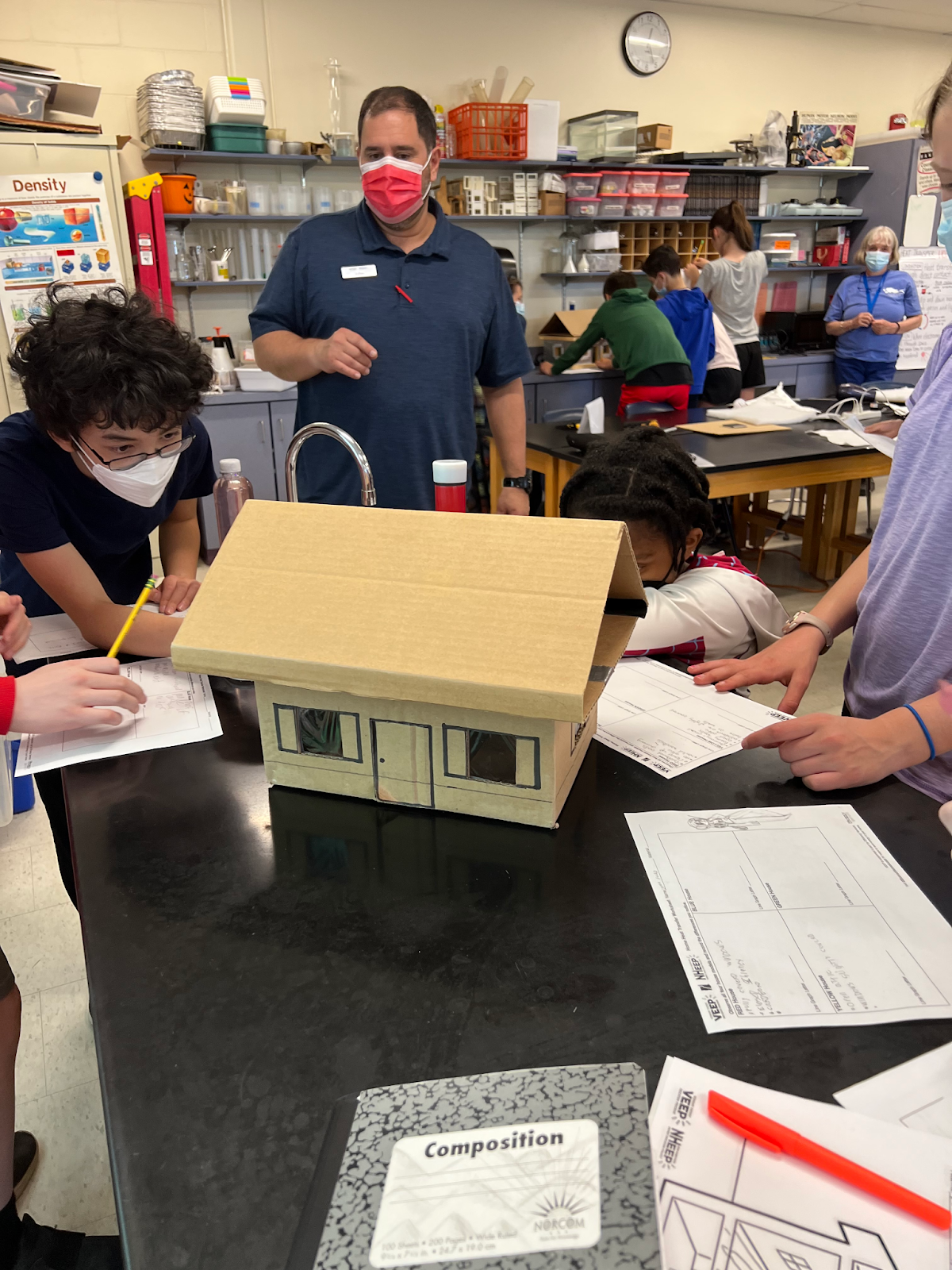 students working on a design challenge involving insulating model homes.