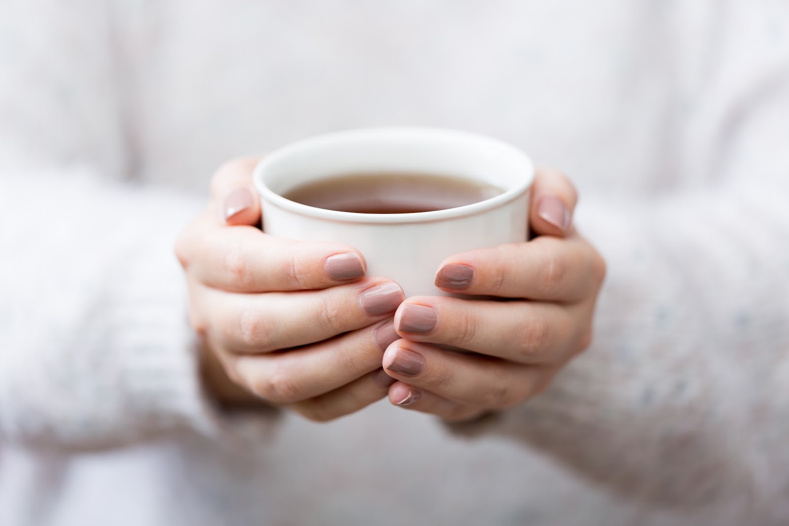 Woman's hands holding a cup of tea