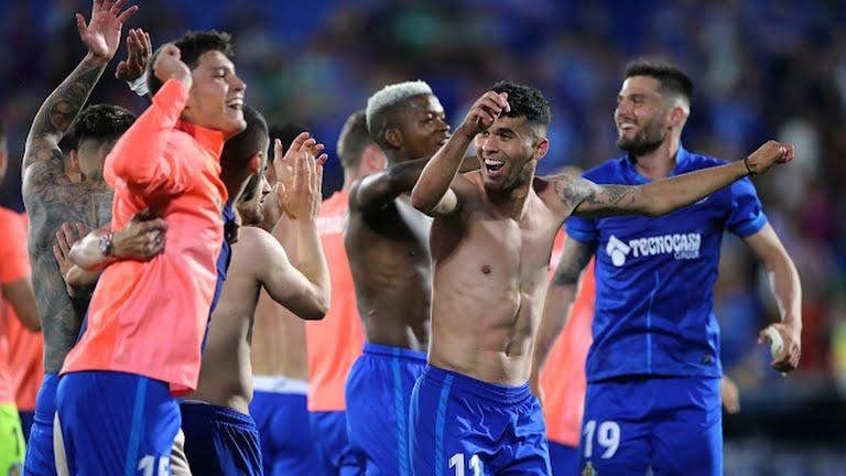 Getafe players celebrate after securing their spot in La Liga next season