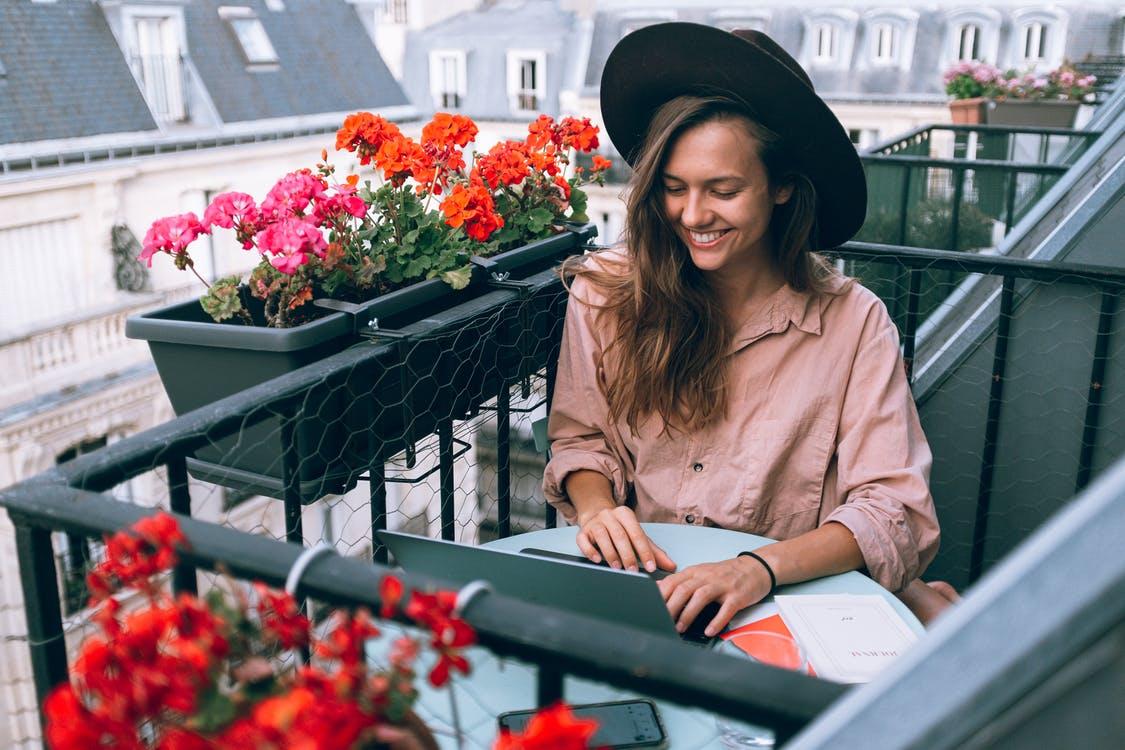 A woman wearing a hat while working outside