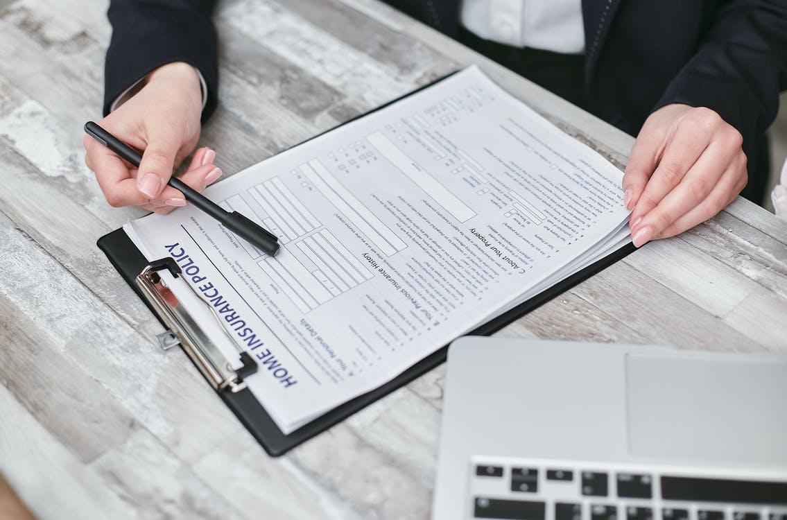 A Person Holding a Black Pen