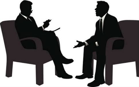 two men sitting down at an interview section