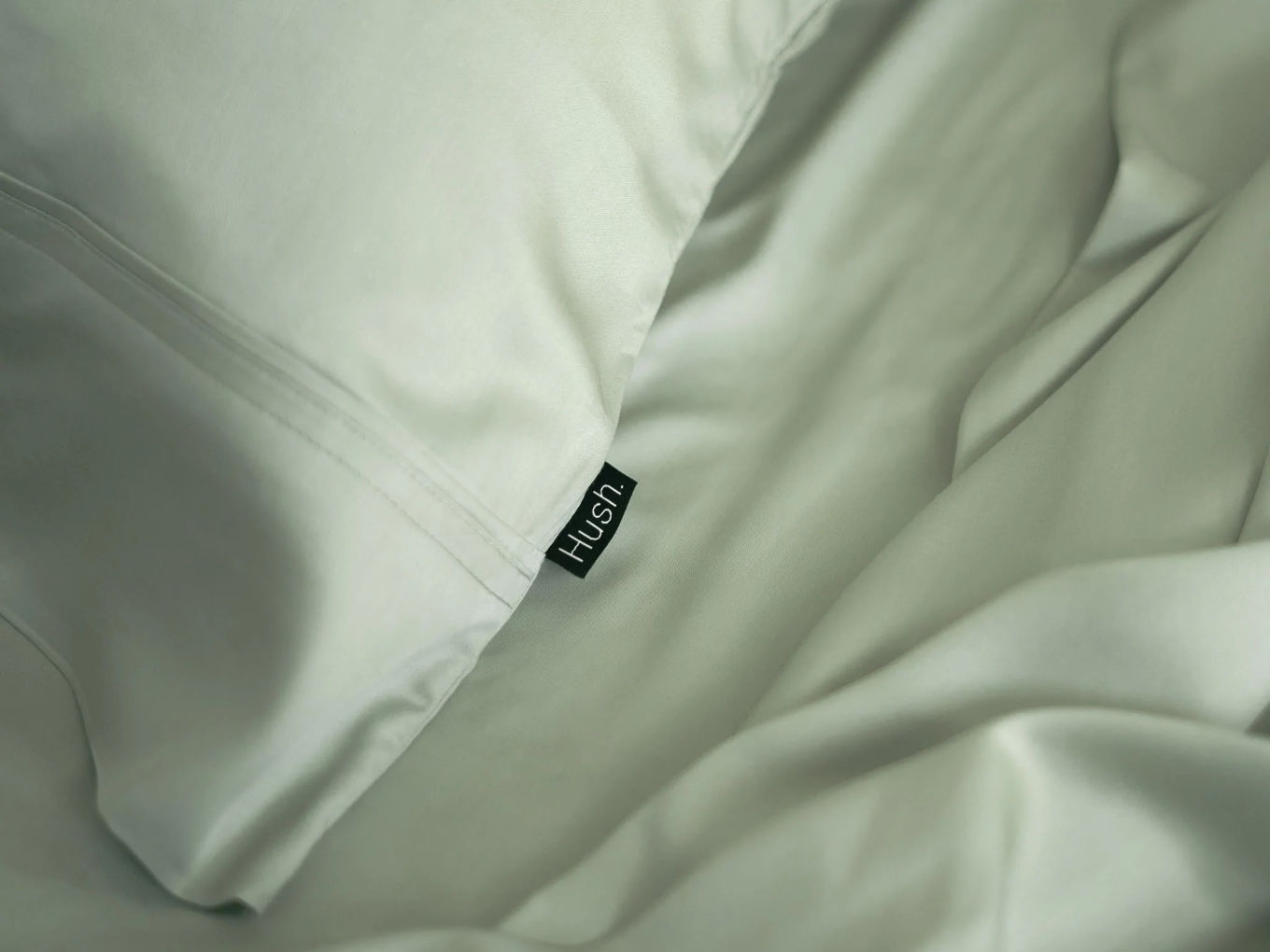 Closeup of sage green Hush pillowcase and sheet