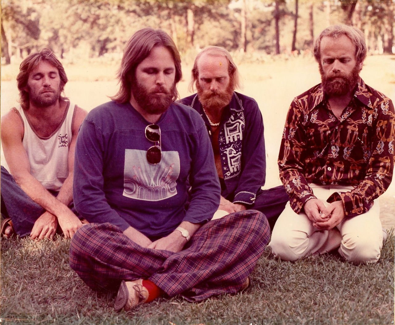 The Beach Boys played at the Jeppesen Stadium in Houston, TX. Here they are meditating backstage. 1974.