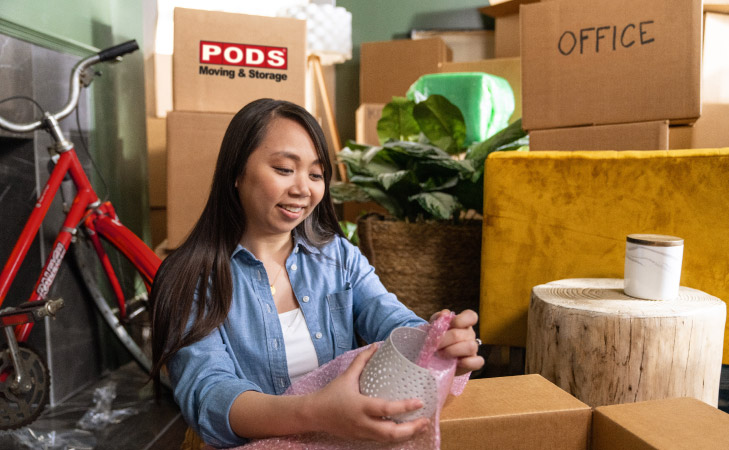 A woman unpacking at her new home in Portland