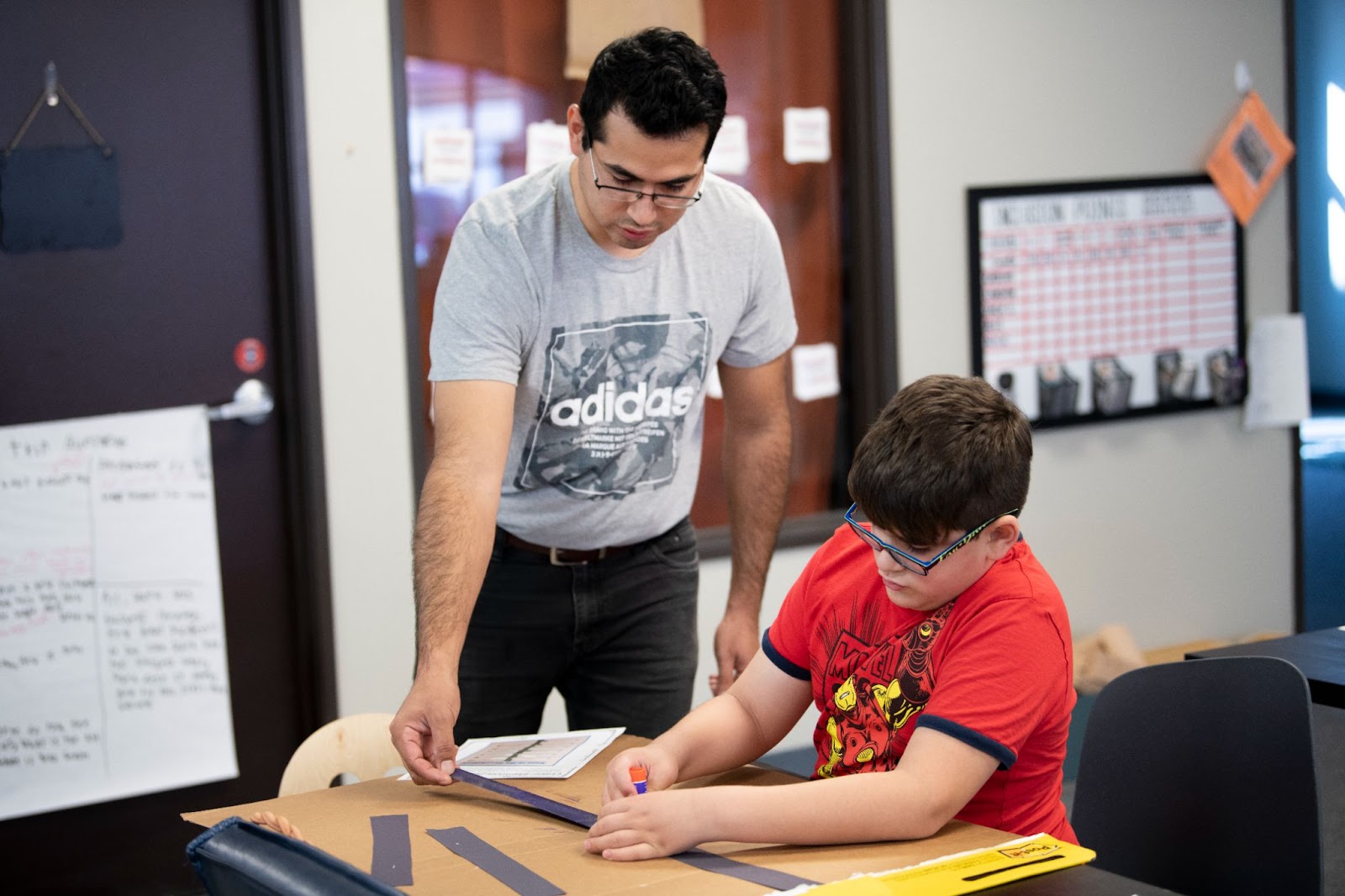 Teacher works with student one on one 