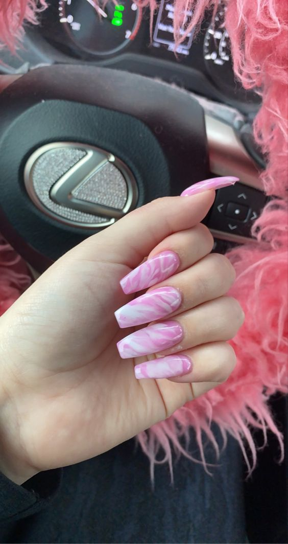 Lady shows off her beautiful pin marble nail design