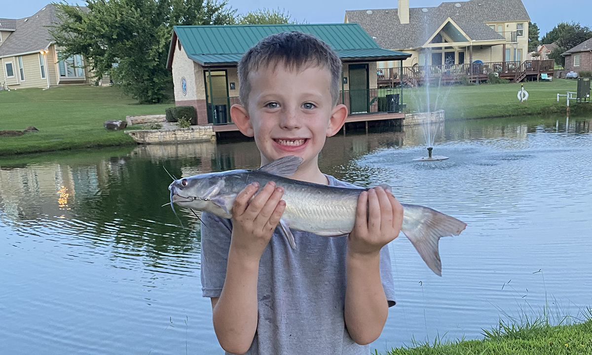 boy holding catfish
