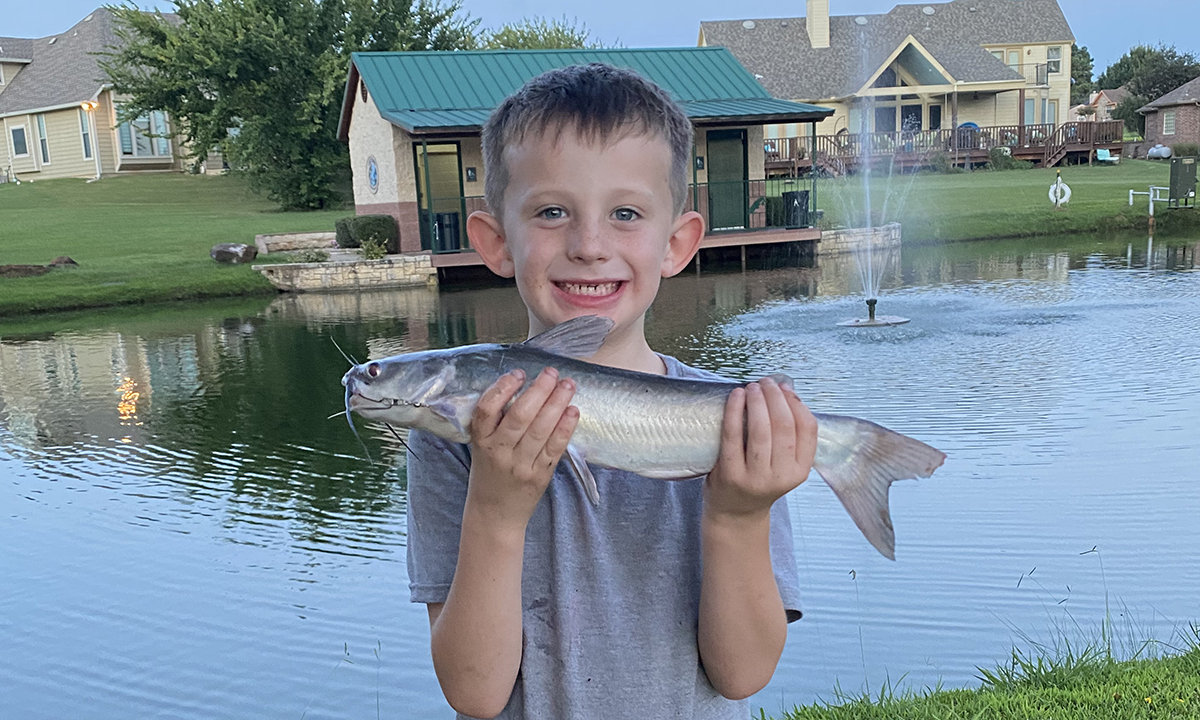 Boy holding catfish