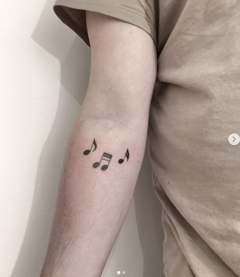 tiny music symbol tattoo